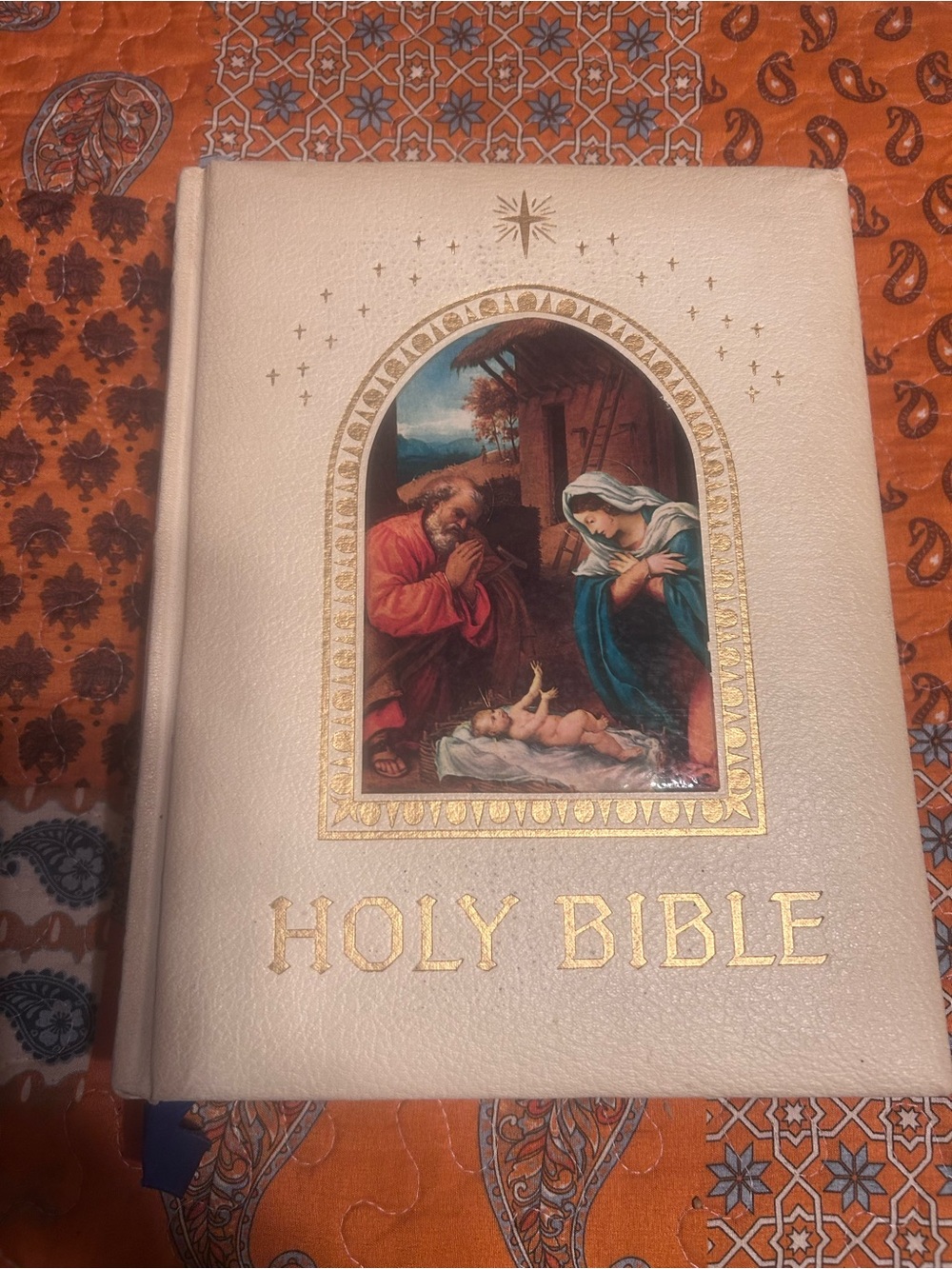 White Holy Bible with Gold Accents and Nativity Illustration